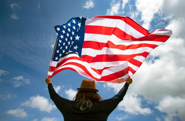 istock Woman with USA flag. 1158747320