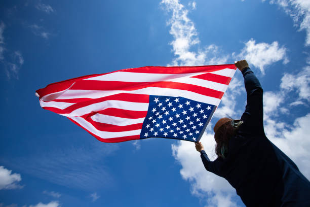 istock Woman with USA flag. 1158747380