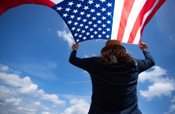 istock Woman with USA flag. 1158747449