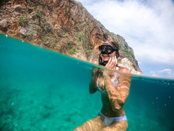 Woman snorkeling in clear water
