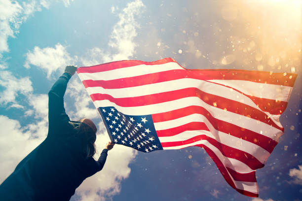 istock Woman with USA flag. 1158748127