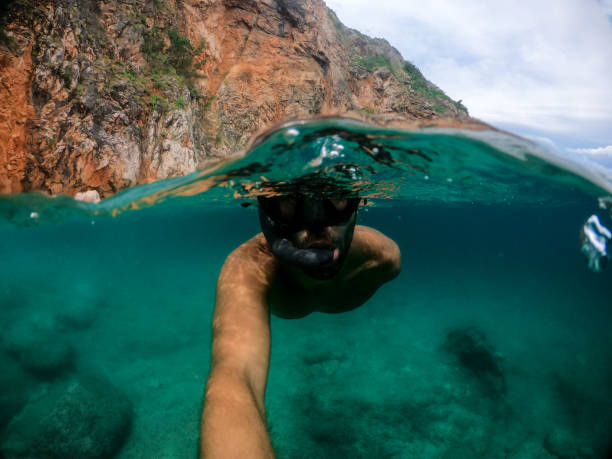 istock Man snorkeling in the sea 1158748131