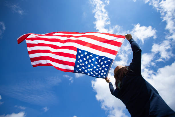 istock Woman with USA flag. 1158748148