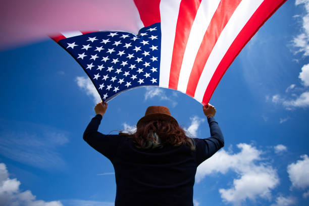 istock Woman with USA flag. 1158748216