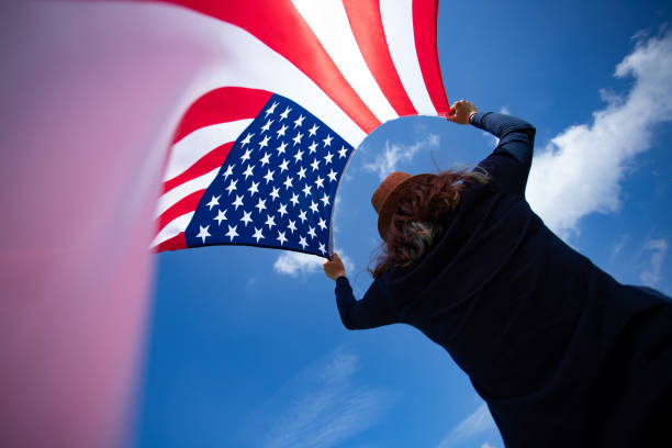 istock Woman with USA flag. 1158748244