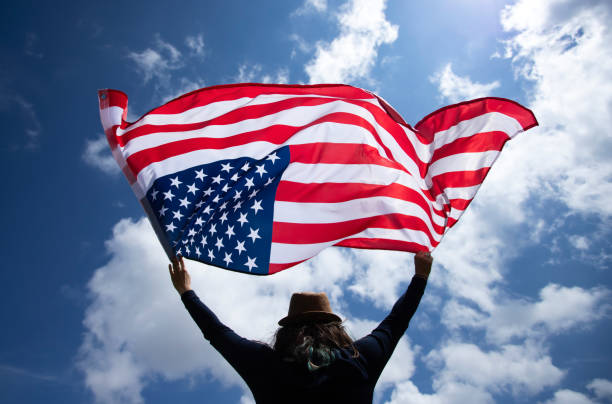 istock Woman with USA flag. 1158748279