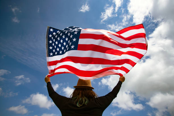 istock Woman with USA flag. 1158748961