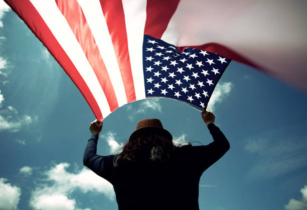 istock Woman with USA flag. 1158749131