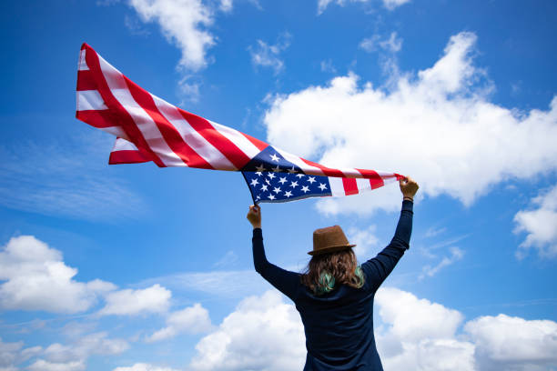istock Woman with USA flag. 1158749181