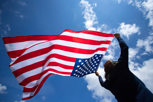 istock Woman with USA flag. 1158749204