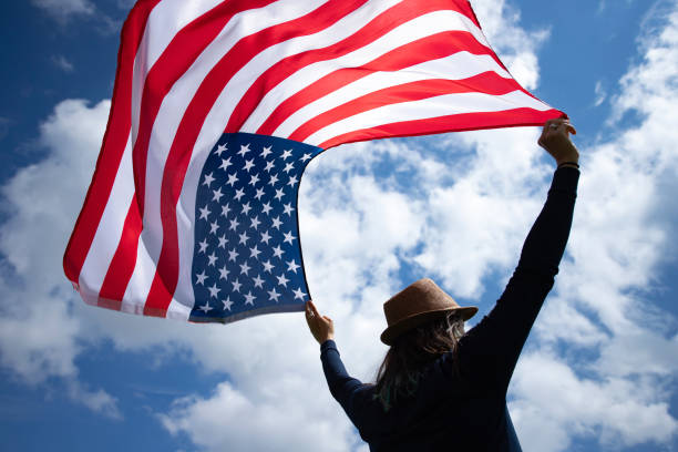 istock Woman with USA flag. 1158749221