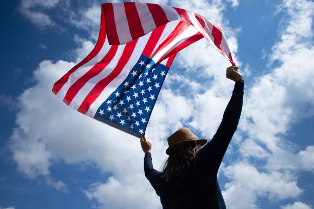 istock Woman with USA flag. 1158749786