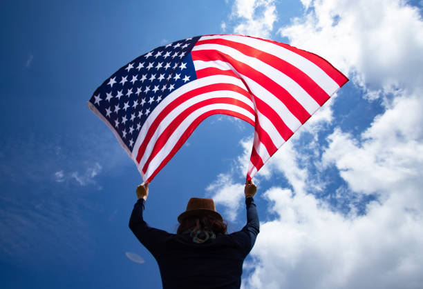 istock Woman with USA flag. 1158749857