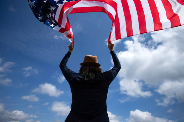istock Woman with USA flag. 1158749957