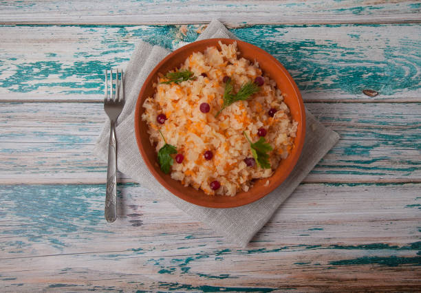 istock fermented cabbage salad with cranberries in pottery and fork stand on a wooden blue table on a linen napkin 1158751206
