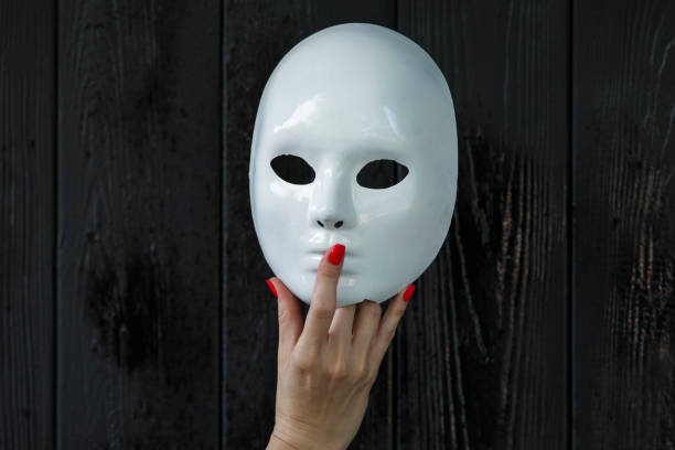 istock female hand holding white mask 1158751394
