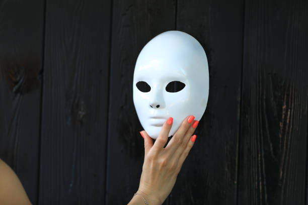 istock female hand holding white mask 1158752005