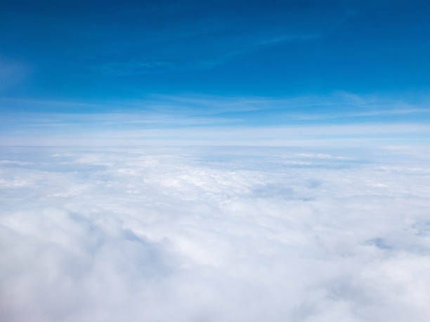 istock Clouds and clear bright blue sky. Aerial view from plane illuminator 1158752491