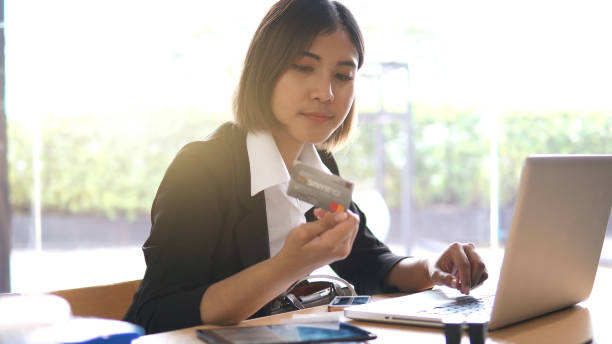 istock businesswoman using credit card. 1158753420