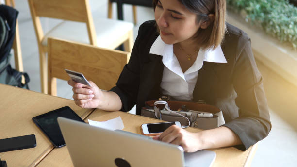 istock businesswoman using credit card. 1158753589