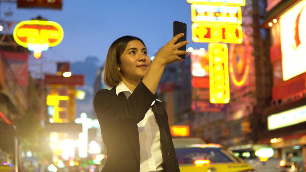 istock Businesswoman using smart phone at night 1158753591