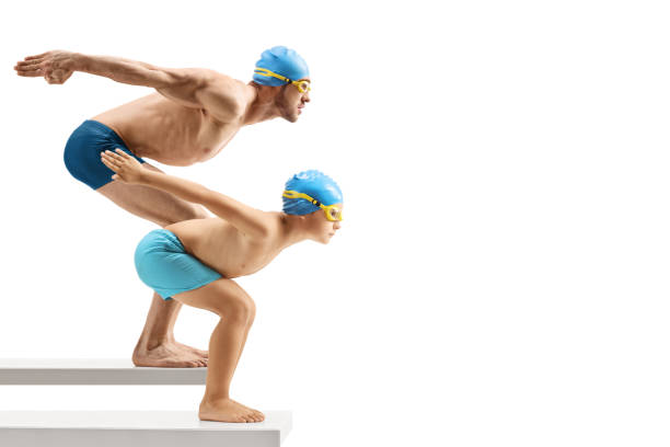 istock Man and child swimmers preparing to jump 1158757109