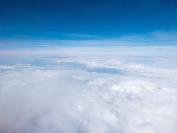 Clouds and clear bright blue sky. Aerial view from plane illuminator