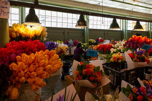United States of America, USA, Seattle, Washington, Pike Place, May 10th 2019. Display of colorful fresh flowers inside the public market building.