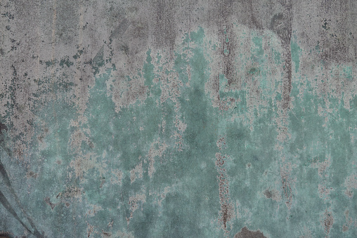 Turquoise and gray textured metal surface background.