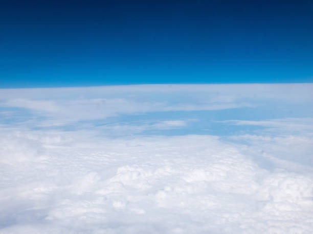 istock Clouds and clear bright blue sky. Aerial view from plane illuminator 1158758847