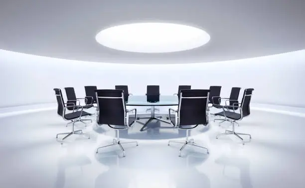 Round meeting room with conference table and modern chairs