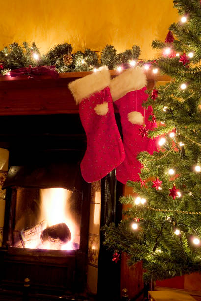 istock Two christmas stockings hanging on a mantle piece 115875926