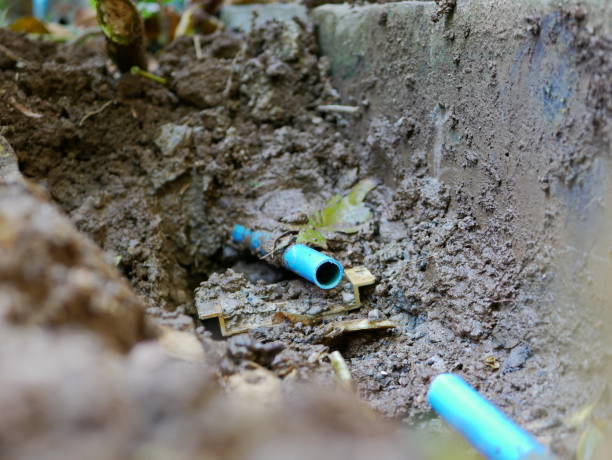 istock Selective focus of underground broken / leaked / cracked PVC, polyvinyl chloride, water pipe is partly cut off, getting ready to be fixed / replaced with the new pipe 1158759734