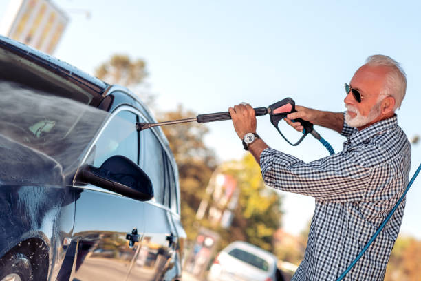 istock Senior man cleaning his new car 1158760369