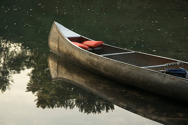 a canoe floating in the calm water of the current river in the Missouri Ozarks