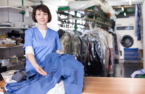 istock Woman worker showing clean shirts 1158763675