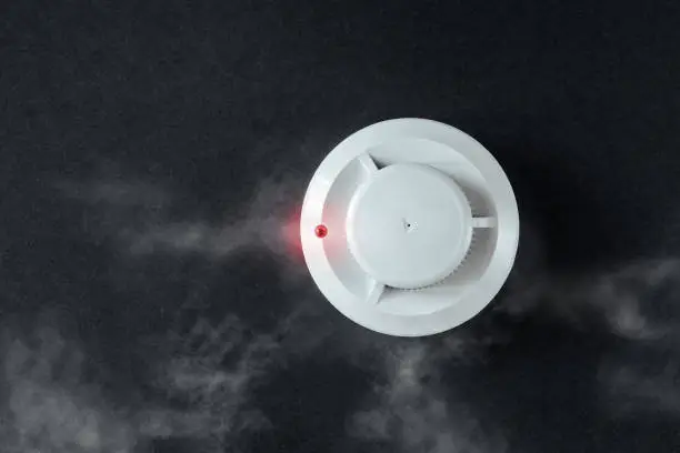 Photo of smoke detector and fire detector on a black background.Fire Alarm flat lay.