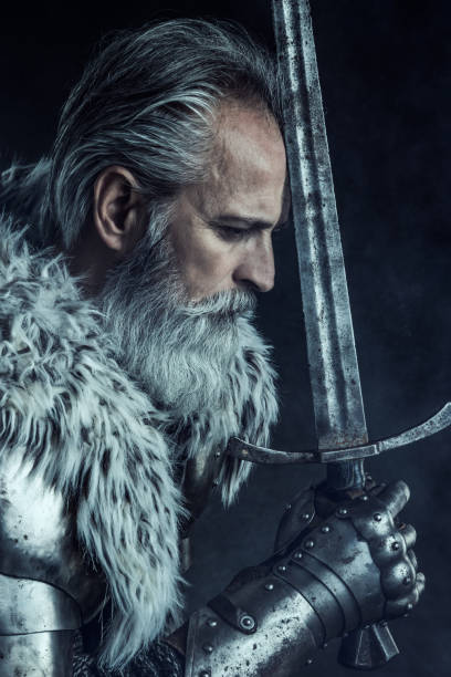 istock Senior knight  wearing traditional clothes with sword 1158765478