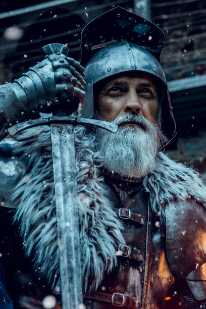 istock Senior knight  wearing traditional clothes with sword 1158766012