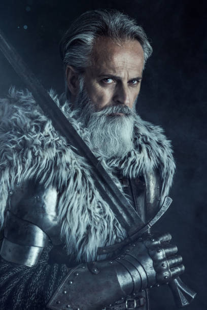 istock Senior knight  wearing traditional clothes with sword 1158766016