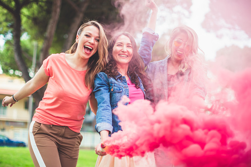 Picture of women having fun with red smoke bomb