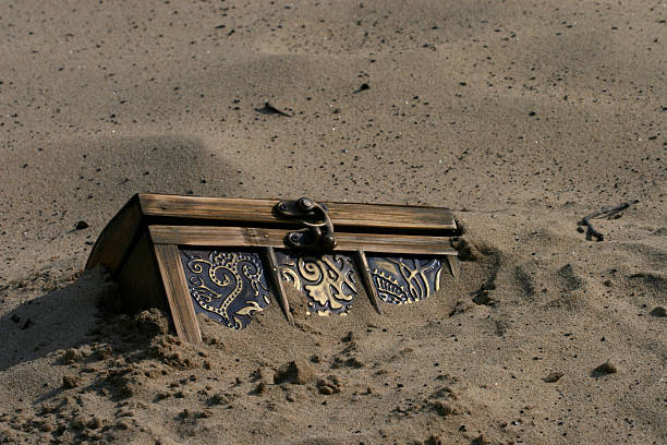 Treasure Chest Treasure chest buried in the sand antiquities photos stock pictures, royalty-free photos & images