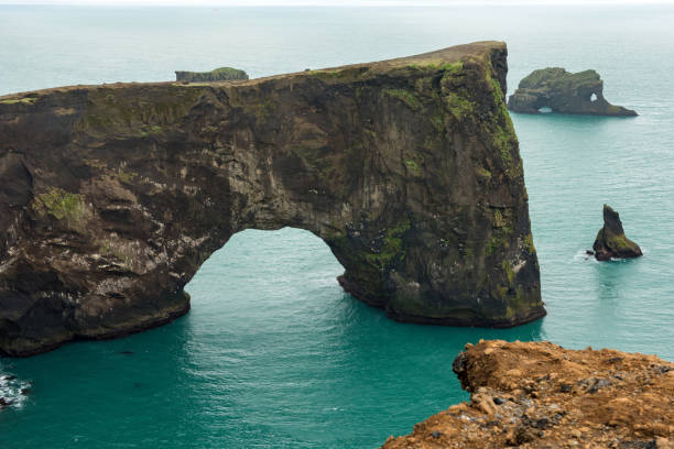 istock Dyrholaey rock arch in the Atlantic ocean, Iceland 1158769662