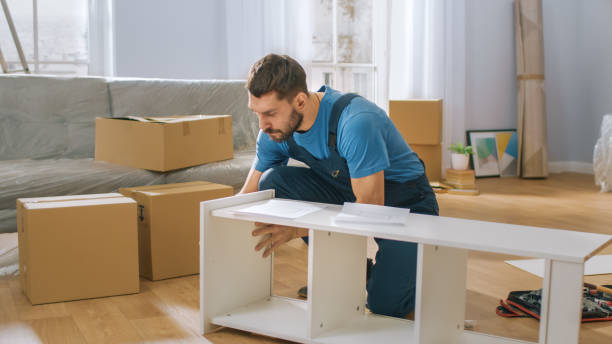 istock Professional Furniture Assembly Worker Assembles Shelf. Professional Handyman Doing Assembly Job Well, Helping People who Move into New House. 1158769712