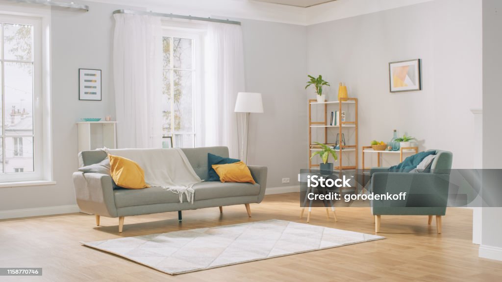 Shot of a Bright Cozy Modern Apartment with Big Windows, Decorations and Stylish Furniture. Living Room Stock Photo