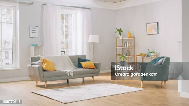 Shot Of A Bright Cozy Modern Apartment With Big Windows Decorations And Stylish Furniture Stock Photo - Download Image Now