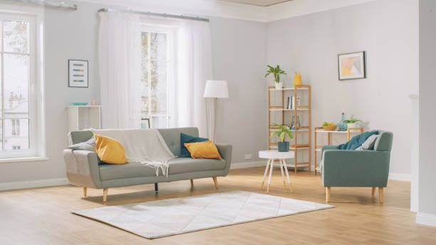 shot of a bright cozy modern apartment with big windows, decorations and stylish furniture. - sala de casa imagens e fotografias de stock
