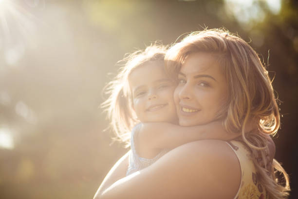 Enjoying love beyond measure. Mother and daughter in nature.