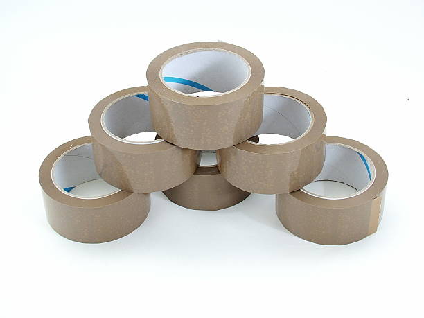 istock Pile of brown parcel tape rolls 1 115877608