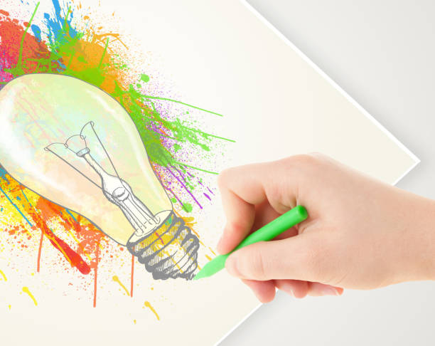 istock Hand drawing on paper a colorful splatter lightbulb 1158776856
